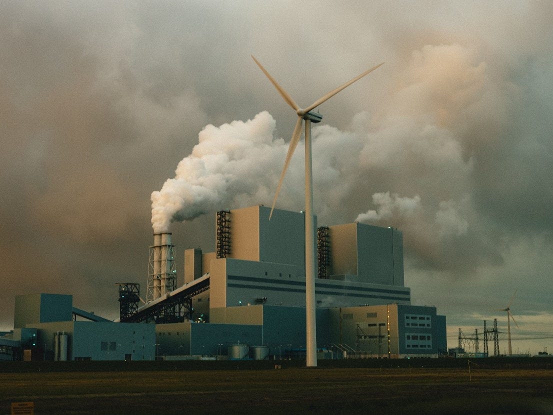 A picture containing sky, chimney, cloud, windmill