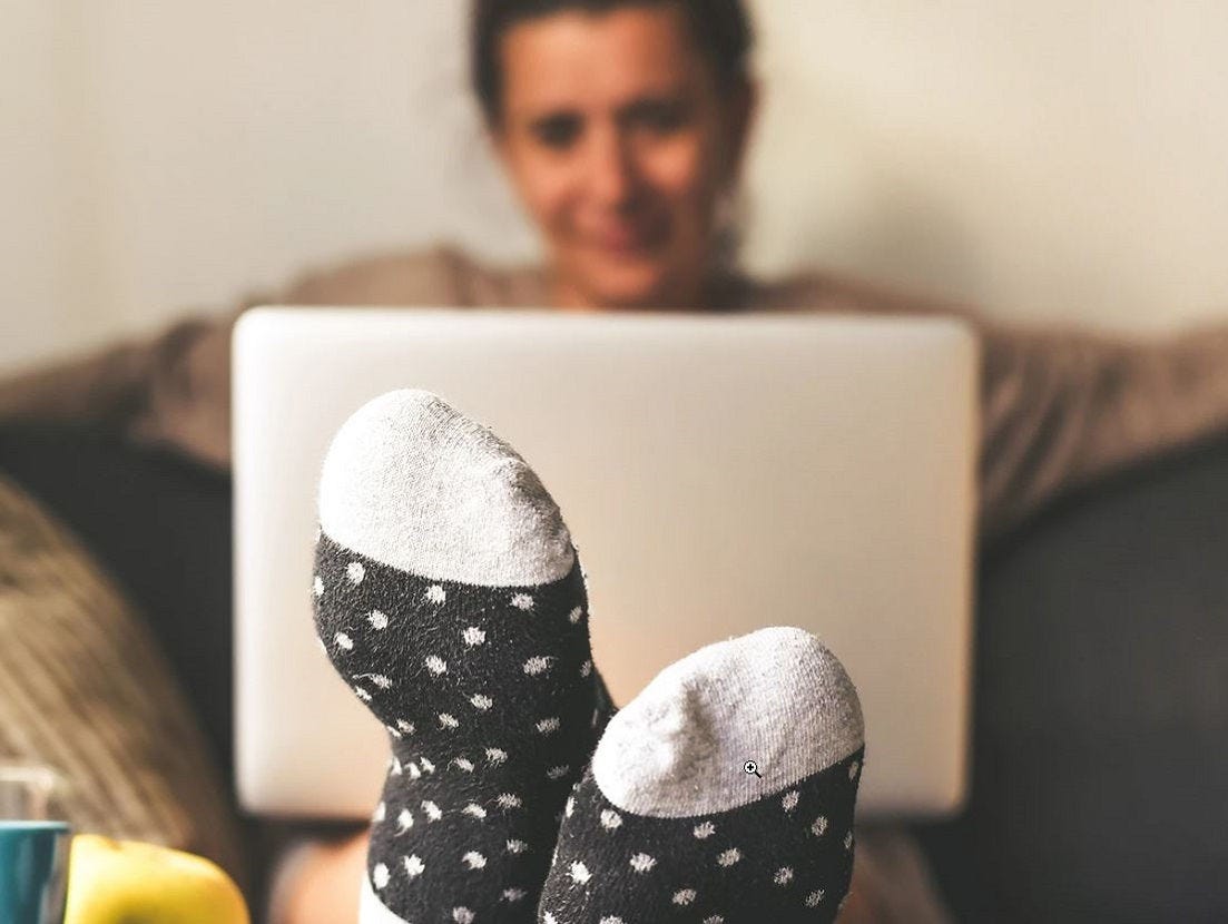 A picture containing person, indoor, sock, wall