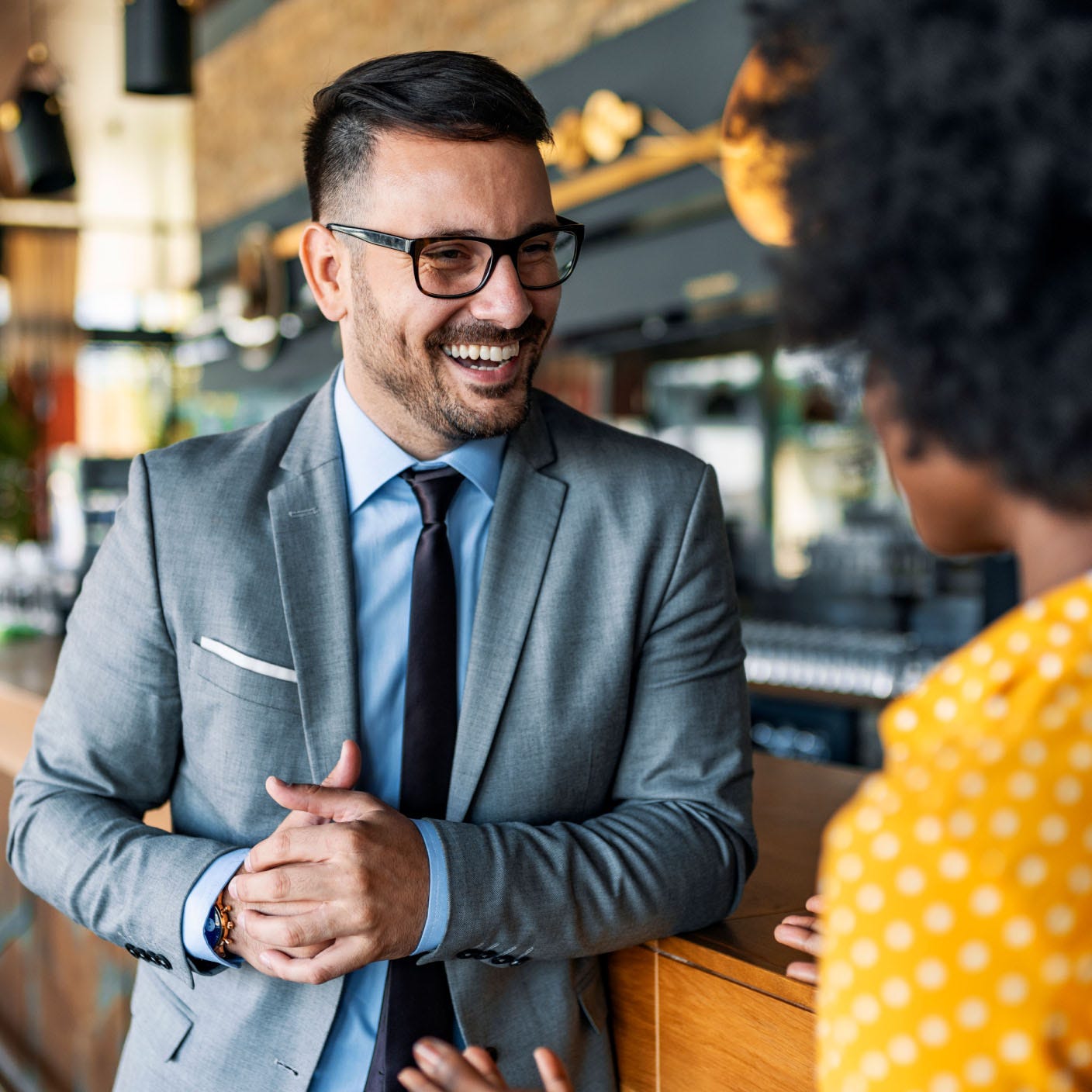 Photograph of a man talking to a woman